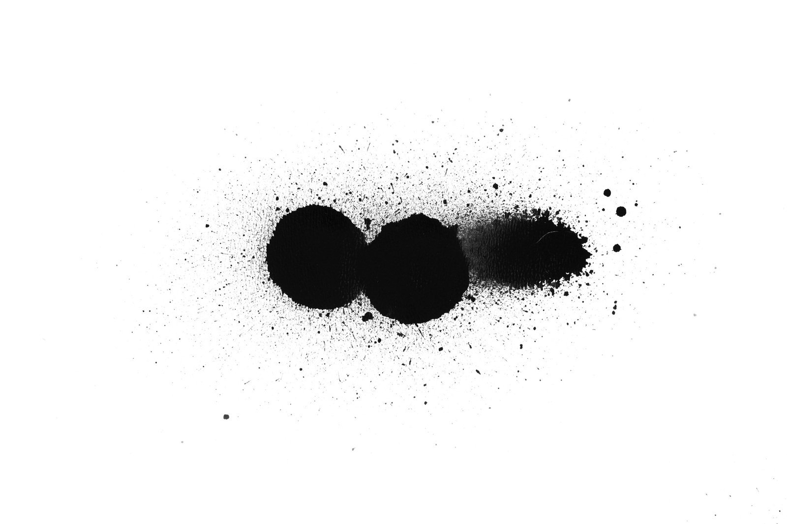 Black color spray paint on a white background paper